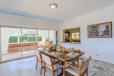 a kitchen and dining room with a table and chairs at #336 Vila Sol by Home Holidays in Sesmarias