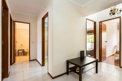 a room with a table and a hallway with mirrors at Amoreira 3br City Center at Homesbyfc in Faro