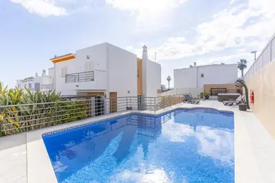 a living room with a tv and a large window at #343 Villa with Pool & Jacuzzi by Home Holidays in Albufeira