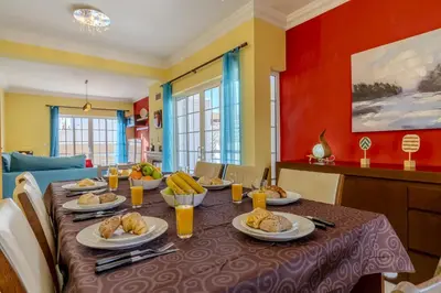 a dining room with a table and chairs at #343 Villa with Pool & Jacuzzi by Home Holidays in Albufeira