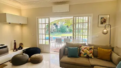 a living room with a couch and an open door at Villa Verde by Check-in Portugal in Vilamoura