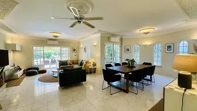 a living room with a table and a dining room at Villa Verde by Check-in Portugal in Vilamoura