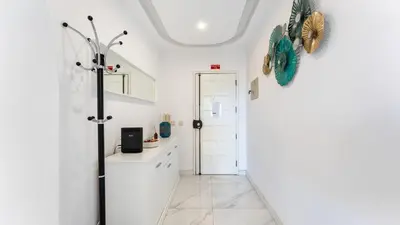 a bathroom with white walls and a hallway with a door at Bright 1BDR Flat in Albufeira by LovelyStay in Albufeira