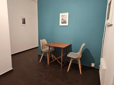 a table and chairs in a room with a blue wall at Blife Eduardya - private rooms at Santantonya 5th floor in Faro