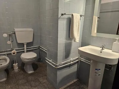 a bathroom with a toilet and a sink at Blife Eduardya - private rooms at Santantonya 5th floor in Faro
