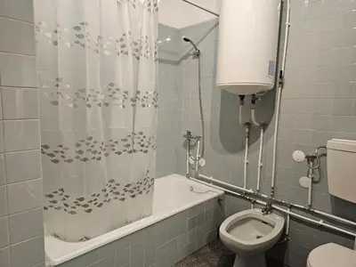 a bathroom with a shower curtain and a toilet at Blife Eduardya - private rooms at Santantonya 5th floor in Faro