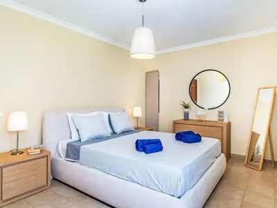 a bedroom with a bed and a mirror at Apartment Mediterrâneo by Interhome in Vilamoura