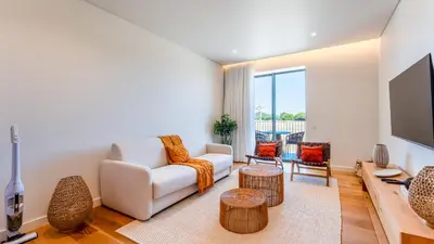 a living room with a couch and a tv at Luxury Flats with Pool in Quarteira by LovelyStay in Quarteira
