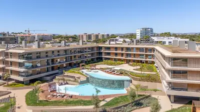 an aerial view of a building with a swimming pool at Luxury Flats with Pool in Quarteira by LovelyStay in Quarteira