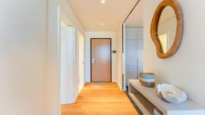 a hallway with white walls and a mirror at Luxury Flats with Pool in Quarteira by LovelyStay in Quarteira
