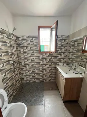 a bathroom with a sink and a toilet and a window at Villa with pool in the Heart of Oura - Albufeira in Albufeira