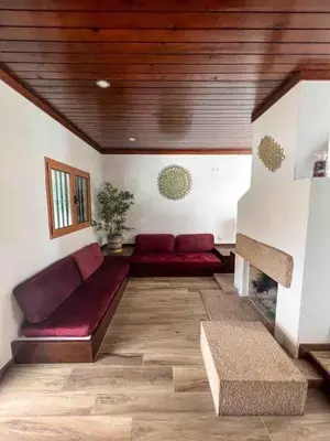 a living room with a red couch and wooden ceilings at Villa with pool in the Heart of Oura - Albufeira in Albufeira