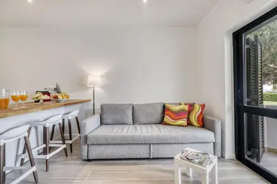 a living room with a couch and a bar at Sunshine Apartment in Vilamoura