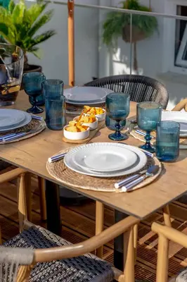 a wooden table with plates and bowls of food on it at Micului Refugiu in Albufeira