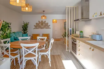a kitchen and dining room with a table and chairs at Micului Refugiu in Albufeira