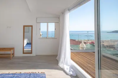 a room with a balcony with a view of the ocean at Micului Refugiu in Albufeira