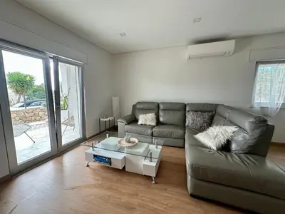 a living room with a couch and a coffee table at Casa Vila Real in Mem Moniz