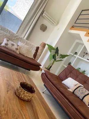 a living room with a couch and a table at Algarve Boho Beach House in Albufeira
