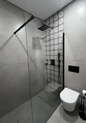 a bathroom with a toilet and a glass shower at Cantinho da Paz in Faro