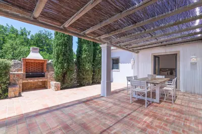 an outdoor patio with a table and a fireplace at Casa Velha in Loulé