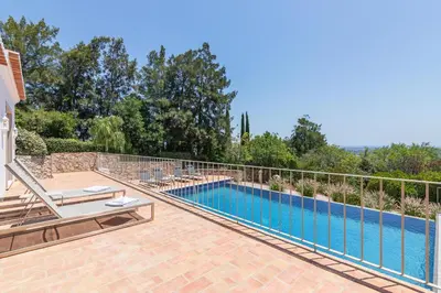 a swimming pool in a villa with a patio and a swimming poolvisorvisor at Casa Velha in Loulé