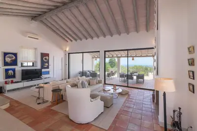a living room with white furniture and glass walls at Casa Velha in Loulé