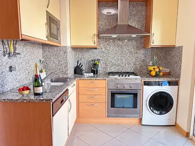 a kitchen with a stove and a dishwasher at Luxurious T2 with Pool & Breathtaking Ocean Views by BeCherish in Albufeira