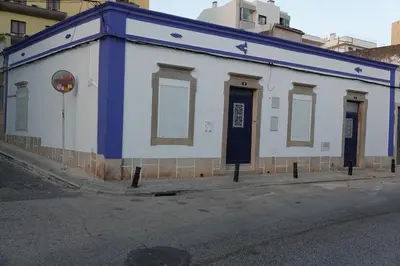 a white and blue building on the side of a street at Blue House - City's Heart in Faro