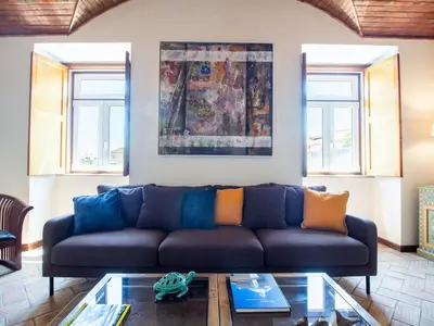 a living room with a blue couch and a glass table at Casa Algarvia Senhorial by Stay ici Algarve Holiday Rental in Albufeira