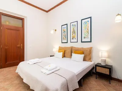 a white bedroom with a large bed with towels on it at Casa Algarvia Senhorial by Stay ici Algarve Holiday Rental in Albufeira