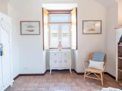 a room with a chair and a window at Casa Algarvia Senhorial by Stay ici Algarve Holiday Rental in Albufeira