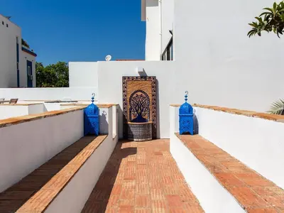 a white building with blue doors and a brick walkway at Casa Algarvia Senhorial by Stay ici Algarve Holiday Rental in Albufeira