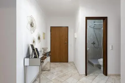 a bathroom with a toilet and a wooden door at Mango 2 - Faro City Center by HD in Faro