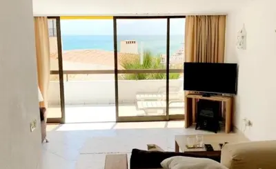 a living room with a view of the ocean at Ocean view Cerro Branco with pool in Albufeira