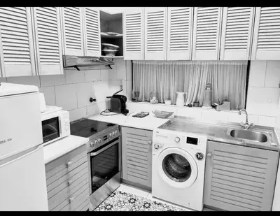 a kitchen with a washing machine and a sink at Ocean view Cerro Branco with pool in Albufeira