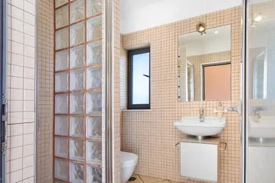 a bathroom with a toilet sink and a mirror at Sunshine Villa em Vilamoura in Vilamoura