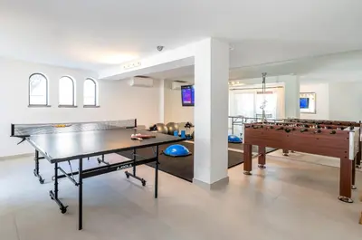 a living room with a ping pong table and a ping pong ball at Villa Cyan by SAPvillas in Vilamoura