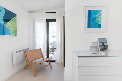 a white room with a chair and a desk at Villa Cyan by SAPvillas in Vilamoura