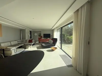 a living room with a couch and a large window at Villa mar e Serra in Loulé