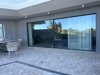 a large sliding glass door in a house with a patio at Villa mar e Serra in Loulé