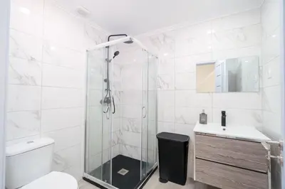 a bathroom with a shower and a toilet and a sink at Casa Biabella in Albufeira