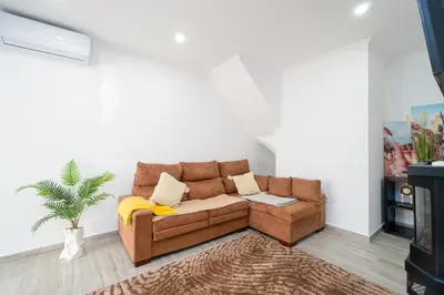 a brown couch in a living room with a rug at Casa Biabella in Albufeira