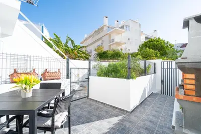 a patio with a table and chairs and a fence at Casa Biabella in Albufeira