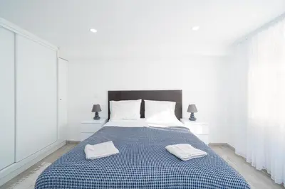a bedroom with a bed with two towels on it at Casa Biabella in Albufeira