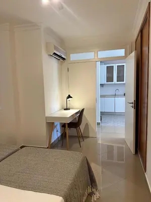a bedroom with a bed and a desk and a table at Vale de Lobo - stylish beach and golf retreat in Almancil