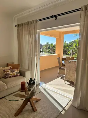 a living room with a couch and a glass table at Vale de Lobo - stylish beach and golf retreat in Almancil