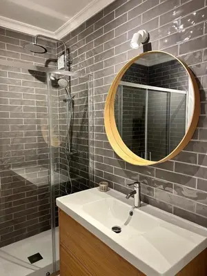 a bathroom with a sink and a mirror and a shower at Vale de Lobo - stylish beach and golf retreat in Almancil