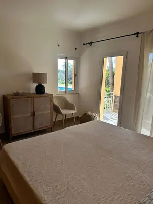 a bedroom with a bed and a desk and a chair at Vale de Lobo - stylish beach and golf retreat in Almancil