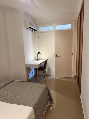 a bedroom with a bed and a desk and a table at Vale de Lobo - stylish beach and golf retreat in Almancil