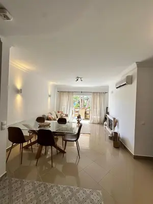 a living room with a table and chairs and a couch at Vale de Lobo - stylish beach and golf retreat in Almancil